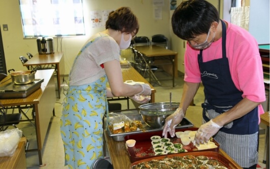 提供するお弁当の盛り付け作業